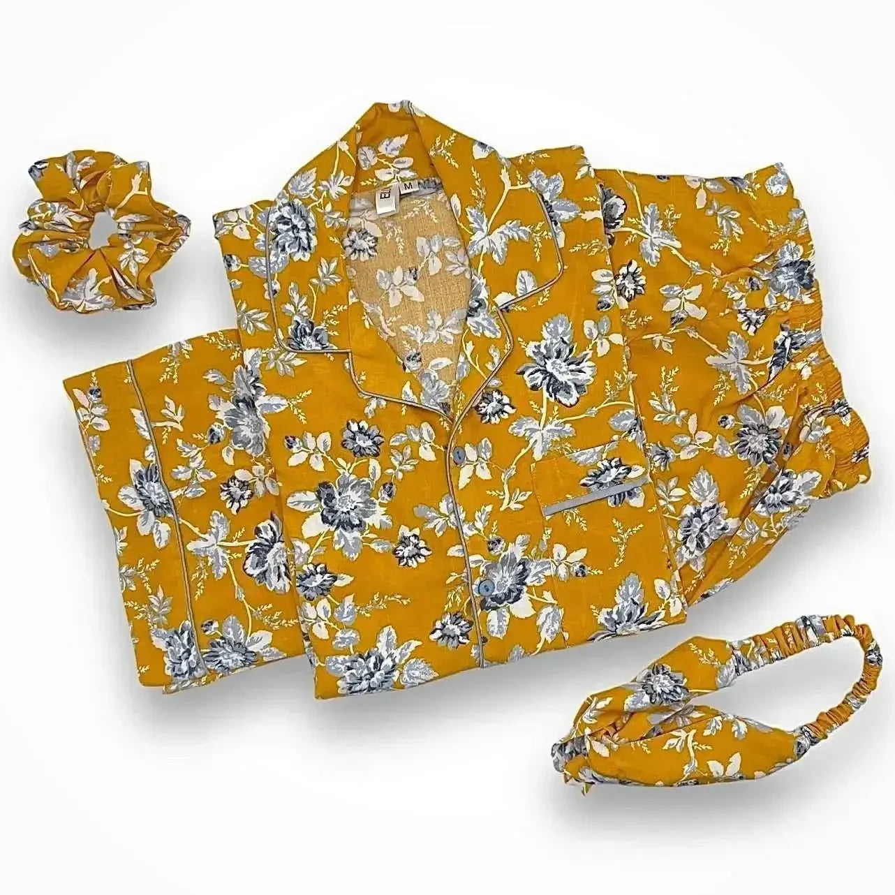 Mustard yellow floral pajama set with top, shorts, matching scrunchie, and headband on white background